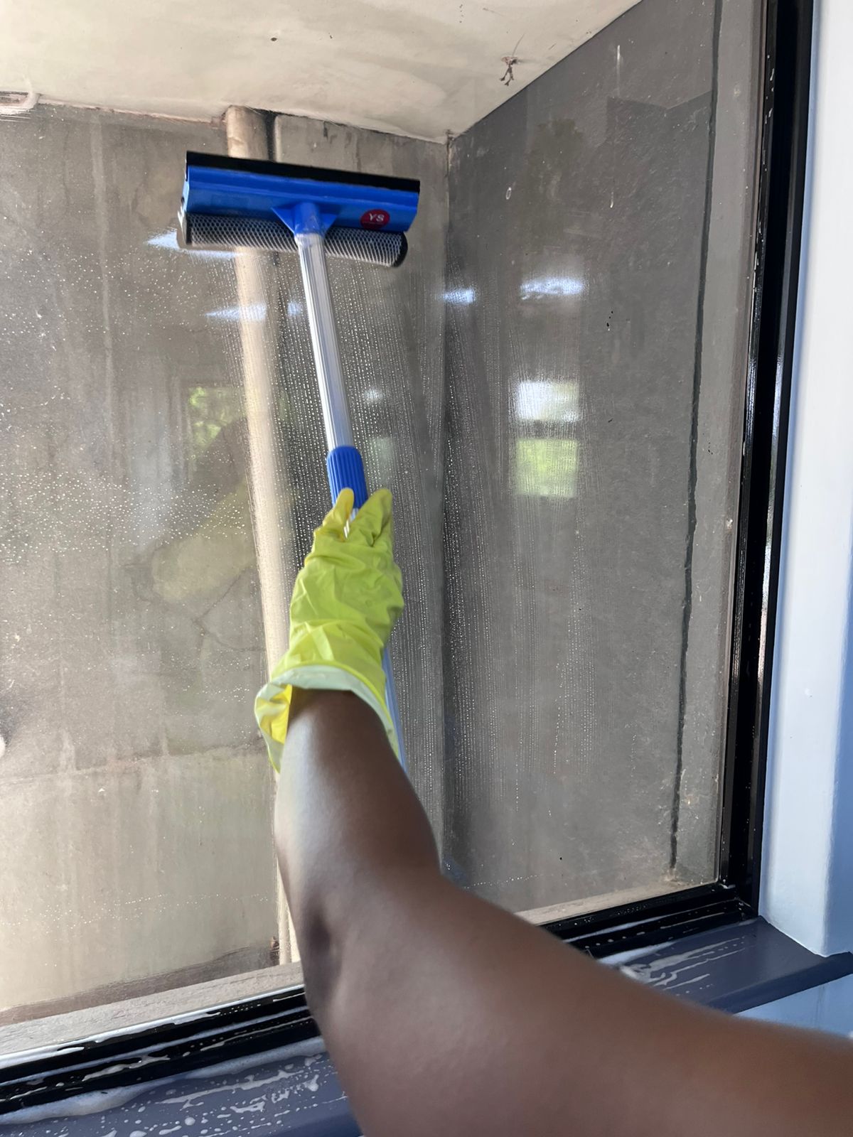 Using a squeegee on a glass window